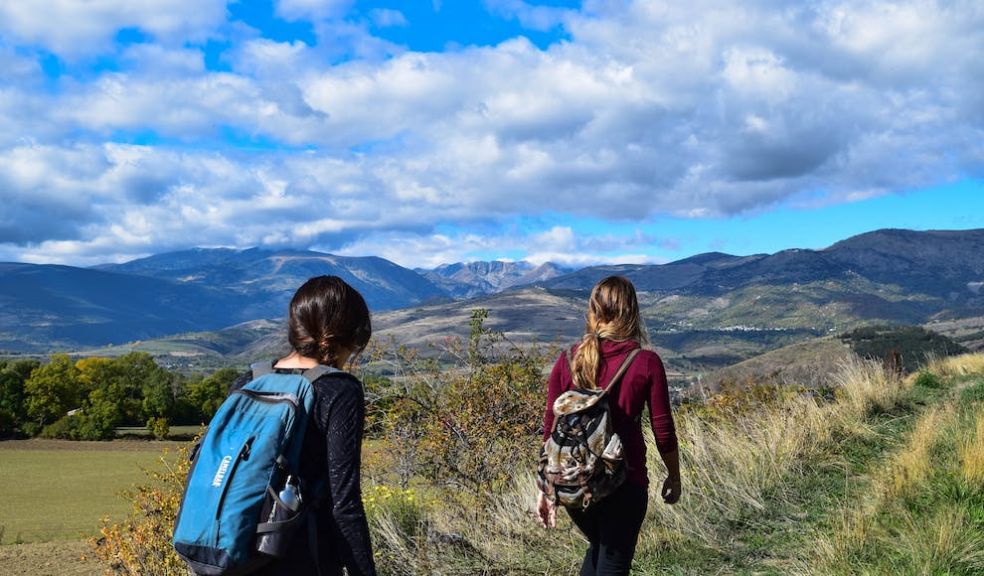 two girls walking over moorland